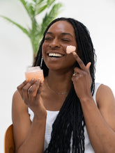 Girl applying clay mask